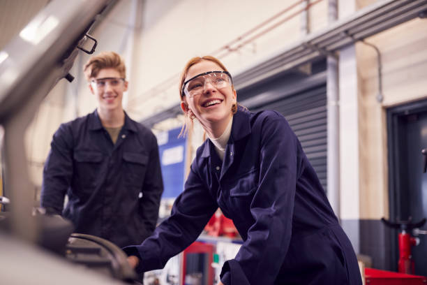 Engineers wearing protective workwear and safety glasses